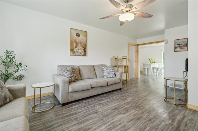 4301 NW 18th St, Oklahoma City, OK 73107 - living room featuring wood finished floors, a ceiling fan, and baseboards