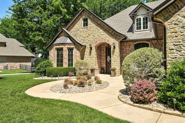 2139 Rivanna Way, Edmond, OK 73034 - view of front of house with stone siding, roof with shingles, and brick siding