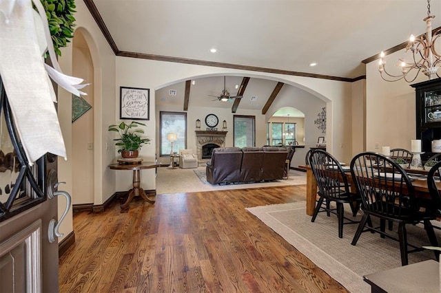 2139 Rivanna Way, Edmond, OK 73034 - dining area featuring arched walkways, a fireplace, ceiling fan, ornamental molding, and wood finished floors