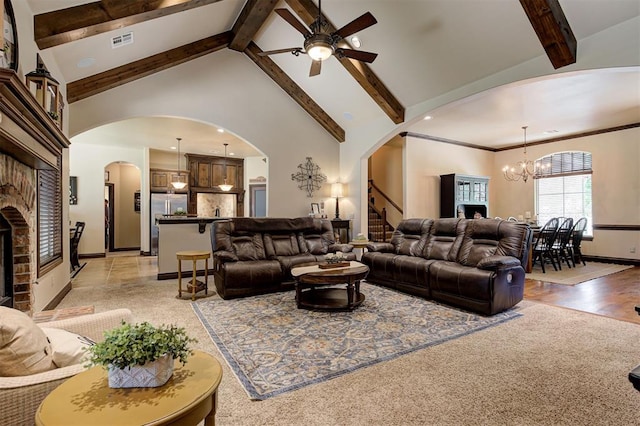 2139 Rivanna Way, Edmond, OK 73034 - living room with arched walkways, high vaulted ceiling, ceiling fan, a chandelier, and beam ceiling
