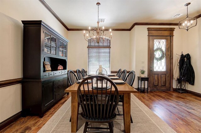 2139 Rivanna Way, Edmond, OK 73034 - dining area with a chandelier, wood finished floors, and ornamental molding