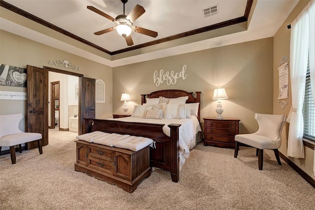 2139 Rivanna Way, Edmond, OK 73034 - bedroom with light carpet, ornamental molding, ensuite bath, a tray ceiling, and ceiling fan