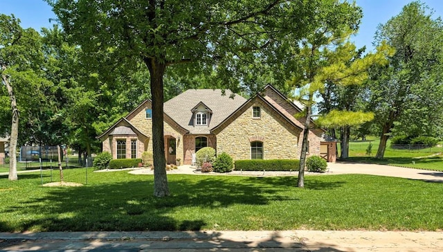 2139 Rivanna Way, Edmond, OK 73034 - french country inspired facade with stone siding and driveway