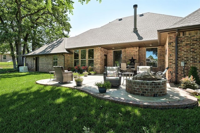 2139 Rivanna Way, Edmond, OK 73034 - rear view of house with brick siding, a patio, a yard, an outdoor fire pit, and a shingled roof