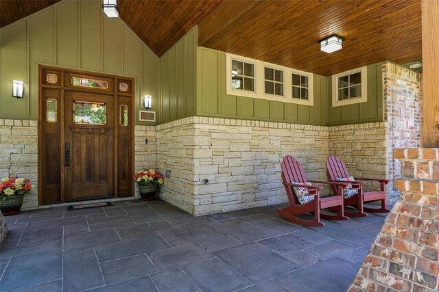 1516 Brook Bank Dr, Jones, OK 73049 - property entrance with board and batten siding, stone siding, and covered porch