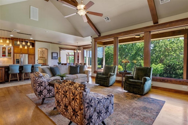 1516 Brook Bank Dr, Jones, OK 73049 - living room with light wood-style flooring, beamed ceiling, ceiling fan, high vaulted ceiling, and a chandelier