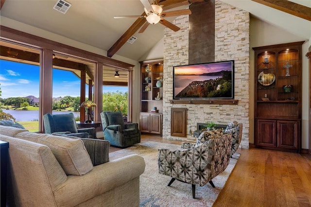 1516 Brook Bank Dr, Jones, OK 73049 - living area with hardwood / wood-style floors, a ceiling fan, beam ceiling, a fireplace, and built in features