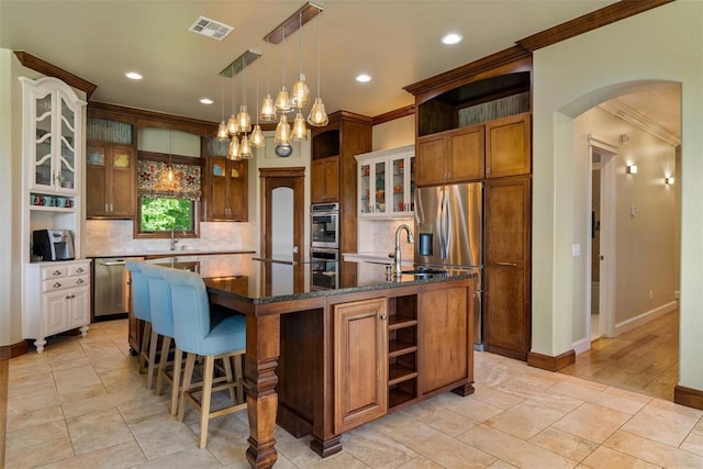 1516 Brook Bank Dr, Jones, OK 73049 - kitchen with open shelves, crown molding, arched walkways, appliances with stainless steel finishes, and a sink