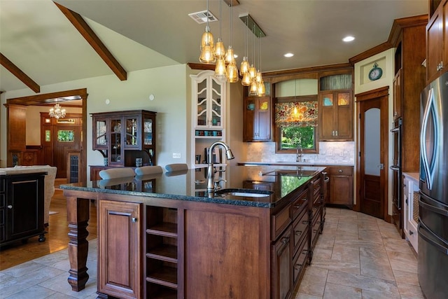 1516 Brook Bank Dr, Jones, OK 73049 - kitchen featuring a chandelier, a sink, appliances with stainless steel finishes, an island with sink, and open shelves