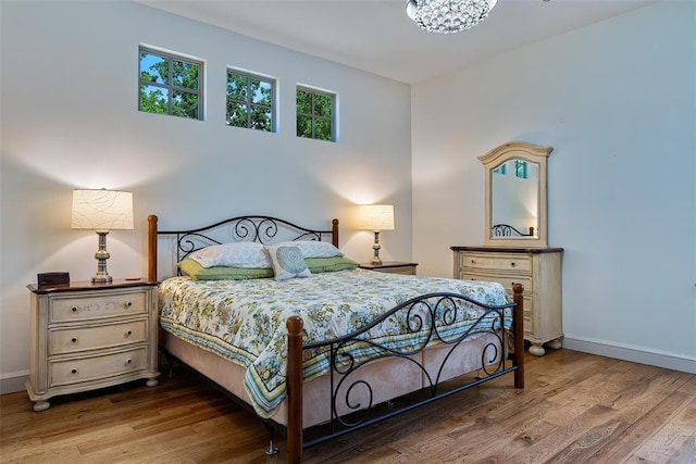 1516 Brook Bank Dr, Jones, OK 73049 - bedroom featuring wood finished floors, baseboards, and a chandelier