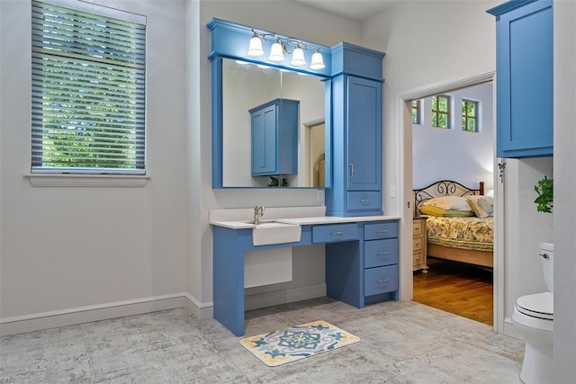 1516 Brook Bank Dr, Jones, OK 73049 - bathroom featuring toilet, vanity, ensuite bath, and baseboards