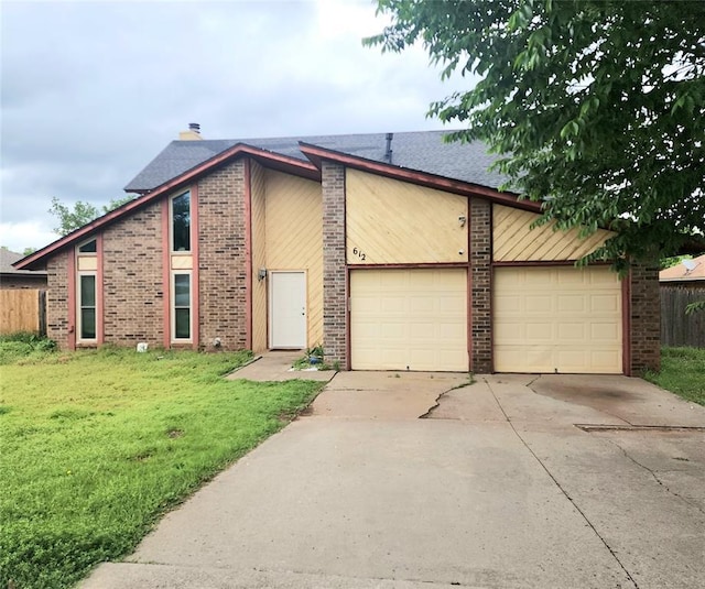 612 Lakeside Cir, Edmond, OK 73012 - view of front facade featuring driveway, a garage, and brick siding