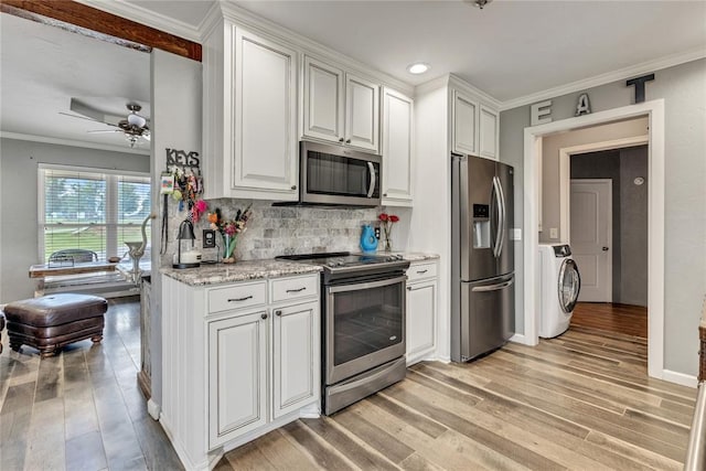 2336 County Road 1222, Blanchard, OK 73010 - kitchen featuring stainless steel appliances, washer / dryer, light wood-style floors, crown molding, and decorative backsplash