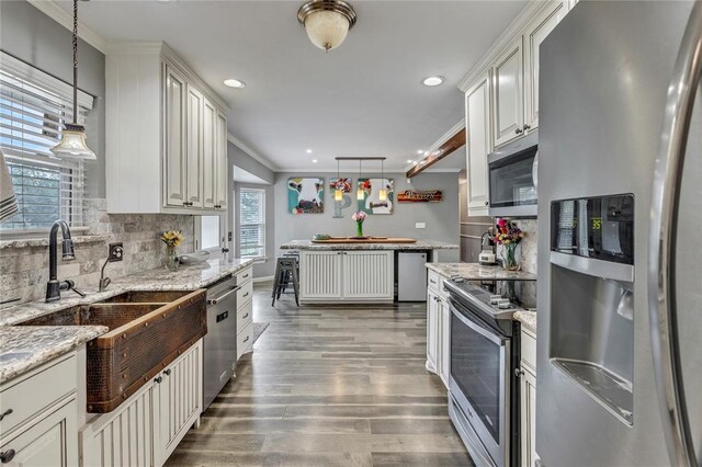 2336 County Road 1222, Blanchard, OK 73010 - kitchen featuring appliances with stainless steel finishes, a sink, wood finished floors, backsplash, and pendant lighting