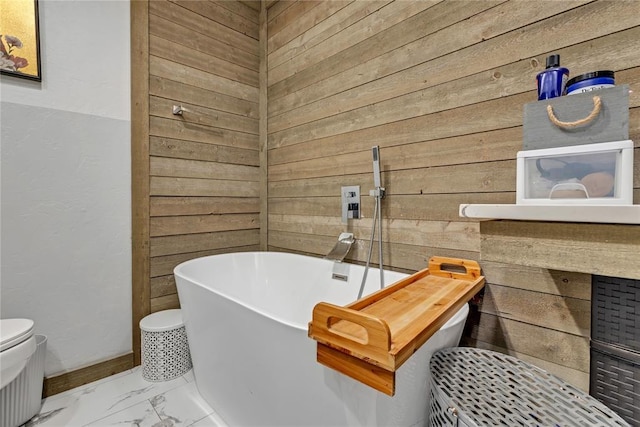 2336 County Road 1222, Blanchard, OK 73010 - bathroom with a freestanding tub, wood walls, marble finish flooring, and toilet