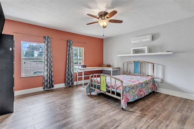 2336 County Road 1222, Blanchard, OK 73010 - bedroom with a wall mounted air conditioner, wood finished floors, baseboards, and a ceiling fan