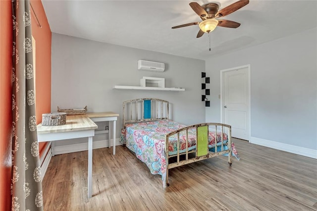 2336 County Road 1222, Blanchard, OK 73010 - bedroom with an AC wall unit, wood finished floors, baseboards, and a ceiling fan