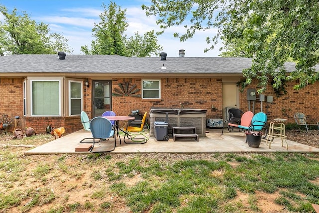 2336 County Road 1222, Blanchard, OK 73010 - rear view of property featuring a hot tub, a patio area, and brick siding
