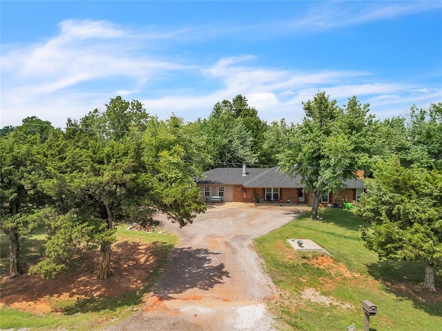 2336 County Road 1222, Blanchard, OK 73010 - view of front of home with driveway, brick siding, and a front lawn