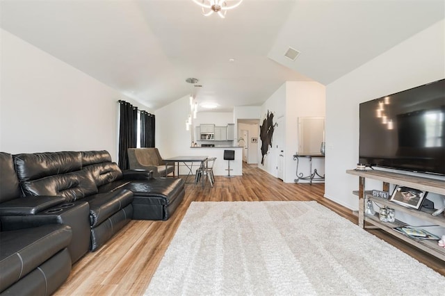 2304 NW 196th Ter, Edmond, OK 73012 - living area featuring lofted ceiling and light wood-type flooring