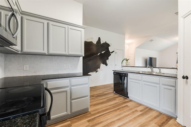 2304 NW 196th Ter, Edmond, OK 73012 - kitchen with black appliances, a sink, backsplash, and light wood finished floors