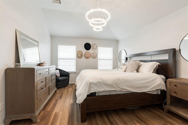 2304 NW 196th Ter, Edmond, OK 73012 - bedroom featuring vaulted ceiling, a chandelier, wood finished floors, and baseboards