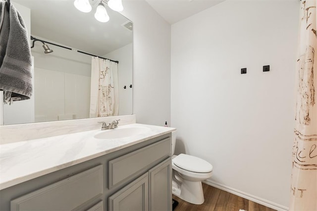 2304 NW 196th Ter, Edmond, OK 73012 - full bath with wood finished floors, vanity, toilet, baseboards, and curtained shower