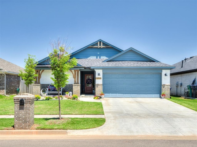 13325 SW 5th St, Yukon, OK 73099 - view of front facade featuring brick siding, an attached garage, driveway, a front lawn, and roof with shingles