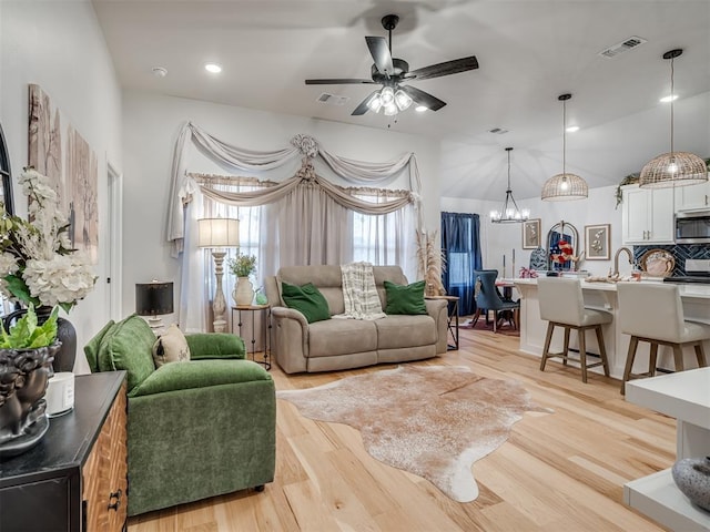 13325 SW 5th St, Yukon, OK 73099 - living area with a chandelier, ceiling fan, light wood-style flooring, and lofted ceiling