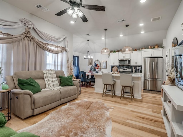 13325 SW 5th St, Yukon, OK 73099 - living area with a chandelier, a ceiling fan, light wood finished floors, and recessed lighting