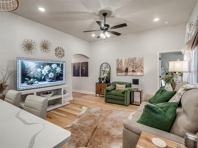 13325 SW 5th St, Yukon, OK 73099 - living room with light wood finished floors, ceiling fan, recessed lighting, arched walkways, and baseboards