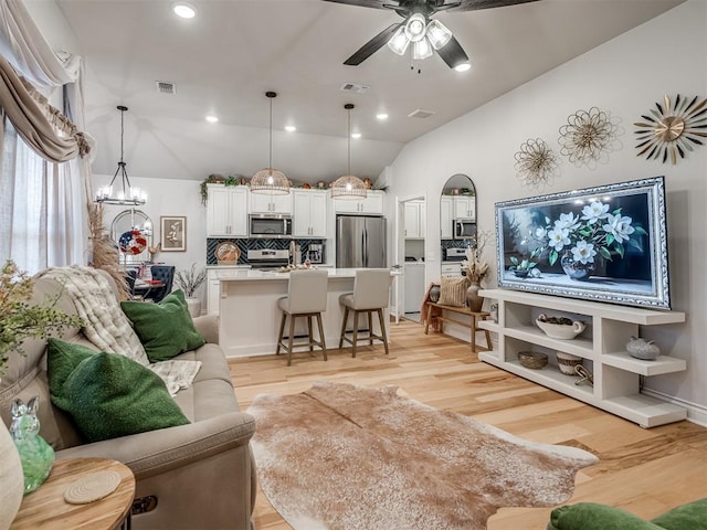 13325 SW 5th St, Yukon, OK 73099 - living room featuring lofted ceiling, light wood-type flooring, ceiling fan, a chandelier, and recessed lighting