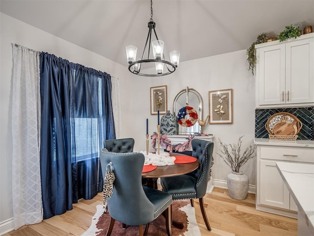 13325 SW 5th St, Yukon, OK 73099 - dining space featuring a chandelier, light wood-style floors, vaulted ceiling, and baseboards