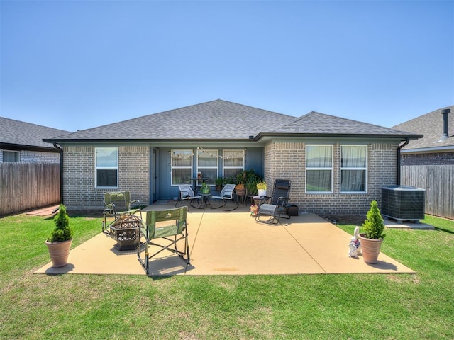 13325 SW 5th St, Yukon, OK 73099 - rear view of house featuring central AC, brick siding, a fire pit, a patio, and a shingled roof