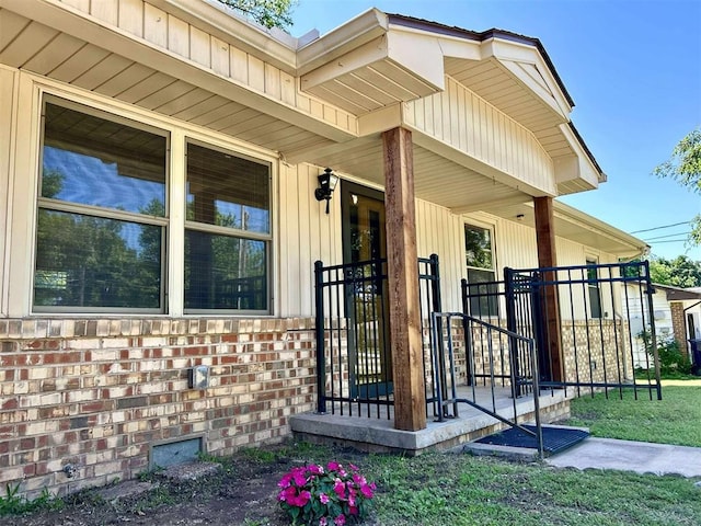 1312 N Carol Ln, Oklahoma City, OK 73127 - view of exterior entry featuring a porch and brick siding