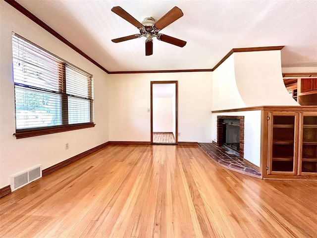 1312 N Carol Ln, Oklahoma City, OK 73127 - unfurnished living room with ornamental molding, light wood finished floors, a fireplace, ceiling fan, and baseboards