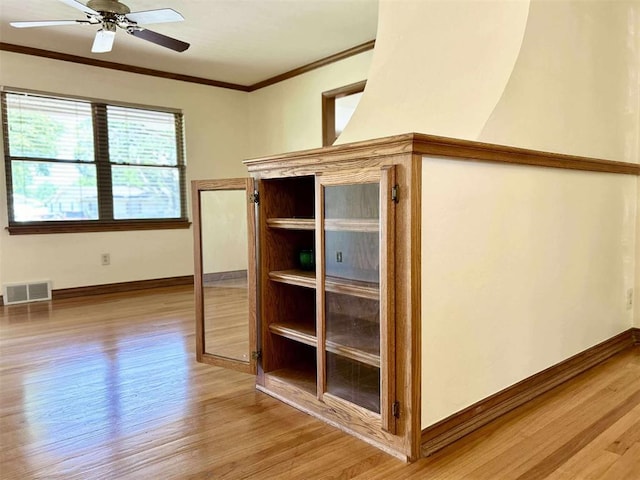 1312 N Carol Ln, Oklahoma City, OK 73127 - detailed view of wood finished floors, crown molding, a ceiling fan, and baseboards