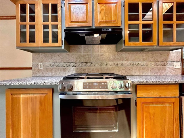 1312 N Carol Ln, Oklahoma City, OK 73127 - kitchen featuring stainless steel gas stove, ventilation hood, tasteful backsplash, and glass insert cabinets