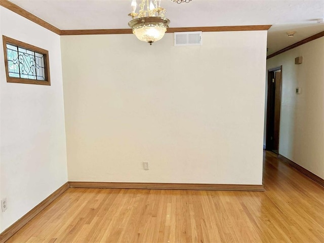 1312 N Carol Ln, Oklahoma City, OK 73127 - empty room featuring crown molding, a chandelier, light wood-type flooring, and baseboards