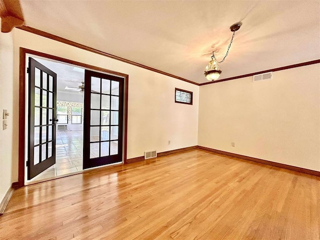 1312 N Carol Ln, Oklahoma City, OK 73127 - unfurnished room with light wood-type flooring, baseboards, french doors, crown molding, and a chandelier
