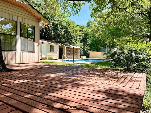 1312 N Carol Ln, Oklahoma City, OK 73127 - wooden deck featuring an outdoor structure and view of wooded area
