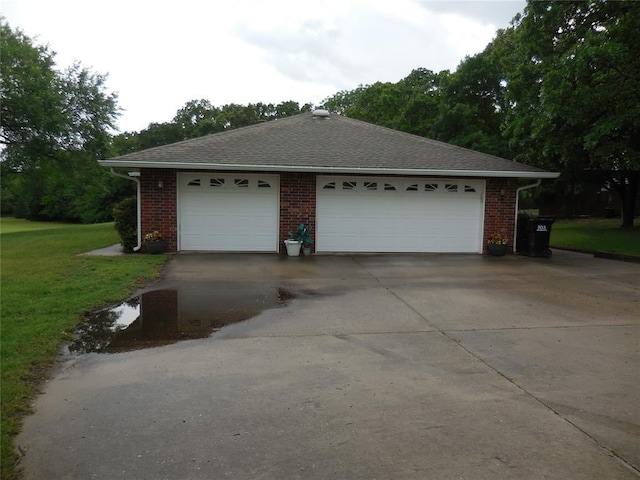 1889 Cobblestone Rd, Sulphur, OK 73086 - view of property exterior featuring a lawn, brick siding, a detached garage, and roof with shingles