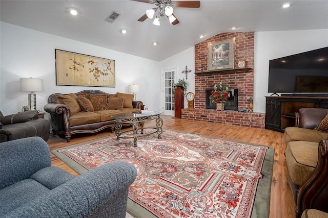 1889 Cobblestone Rd, Sulphur, OK 73086 - living room featuring a ceiling fan, lofted ceiling, wood finished floors, a brick fireplace, and recessed lighting