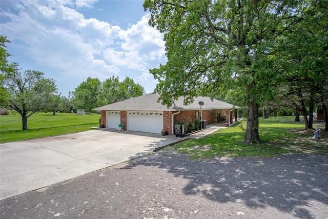 1889 Cobblestone Rd, Sulphur, OK 73086 - ranch-style home with a garage, a front lawn, driveway, and brick siding