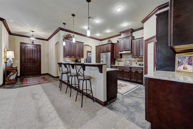 13009 Jasmine Ln, Oklahoma City, OK 73142 - kitchen with stainless steel fridge with ice dispenser, arched walkways, a kitchen breakfast bar, ornamental molding, and backsplash
