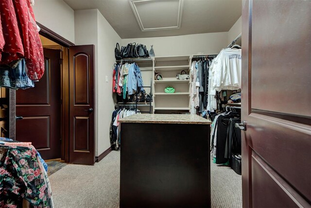 13009 Jasmine Ln, Oklahoma City, OK 73142 - walk in closet with light colored carpet and attic access