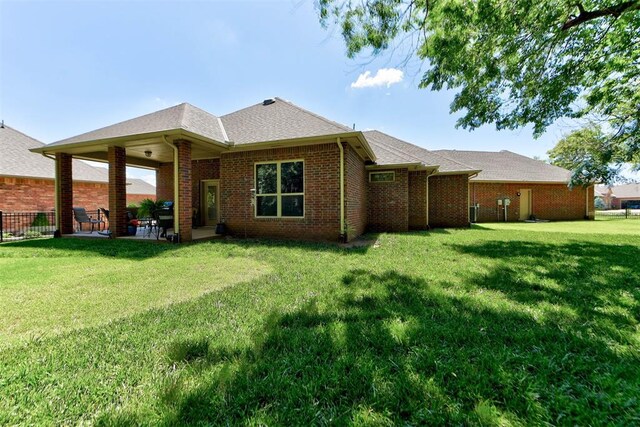 13009 Jasmine Ln, Oklahoma City, OK 73142 - back of property with brick siding, a patio, and a shingled roof