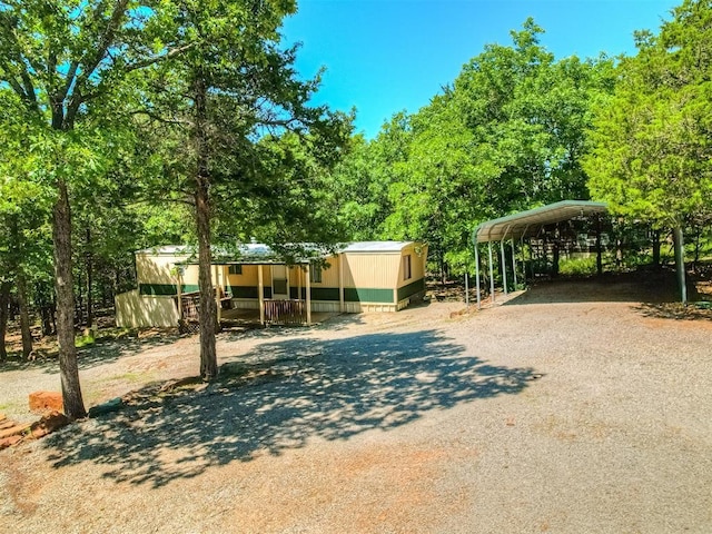 332 Royal Ln, Canadian, OK 74425 - view of front of home featuring a detached carport, driveway, and covered porch