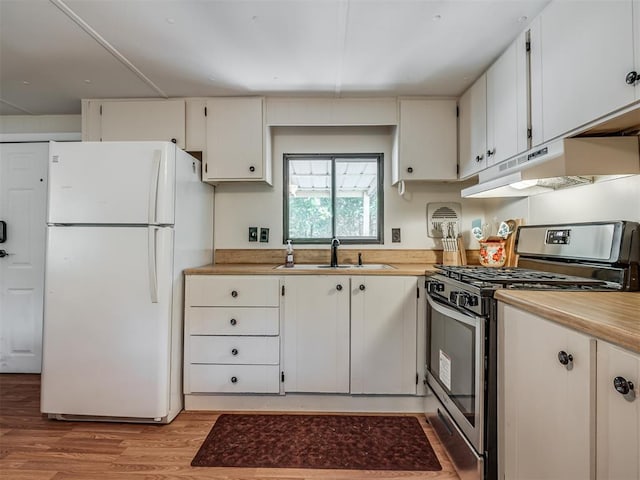 332 Royal Ln, Canadian, OK 74425 - kitchen with stainless steel gas range, freestanding refrigerator, under cabinet range hood, light countertops, and light wood-type flooring