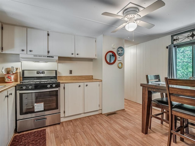 332 Royal Ln, Canadian, OK 74425 - kitchen featuring stainless steel gas range, under cabinet range hood, light wood-type flooring, light countertops, and white cabinets